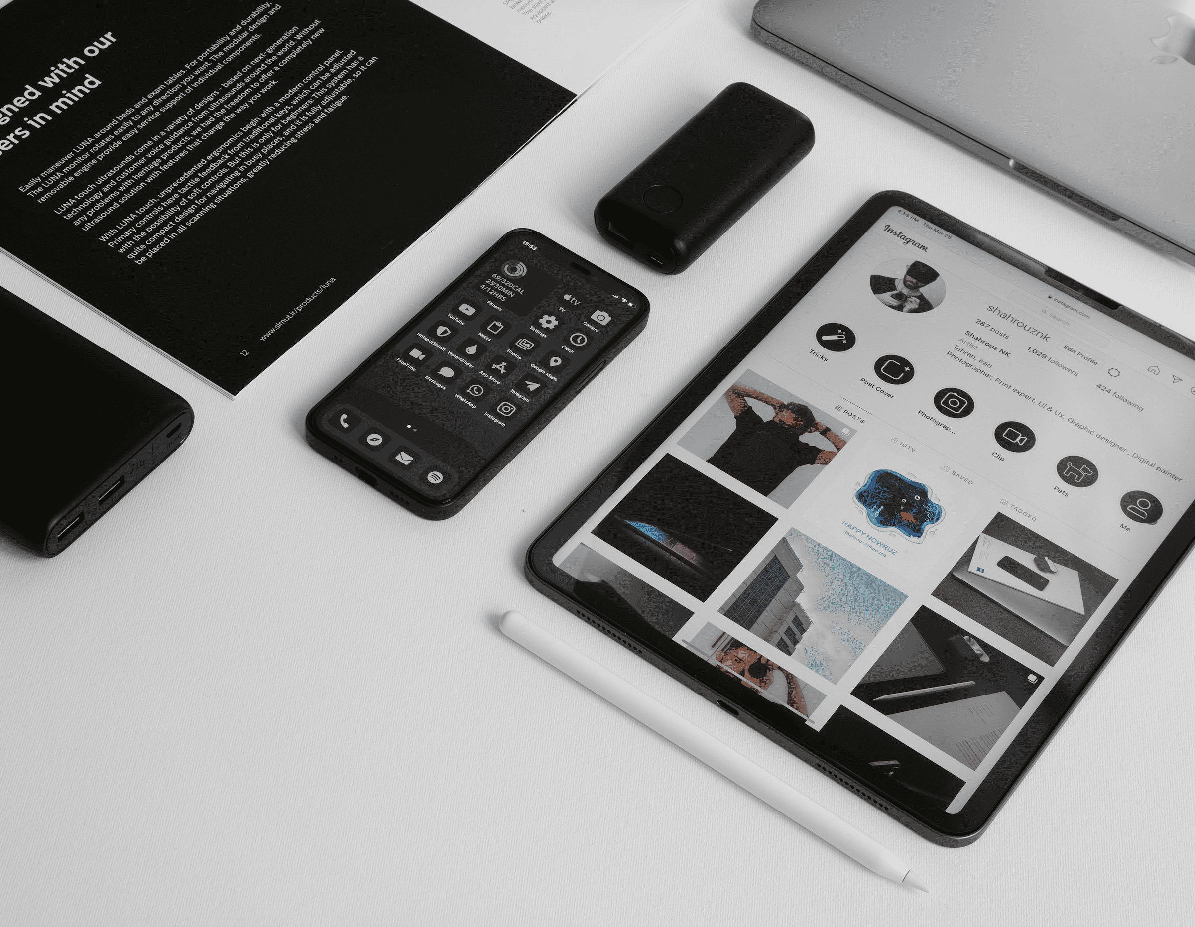 Brand identity mockup with matching stationery, smartphones and tablet on a white surface